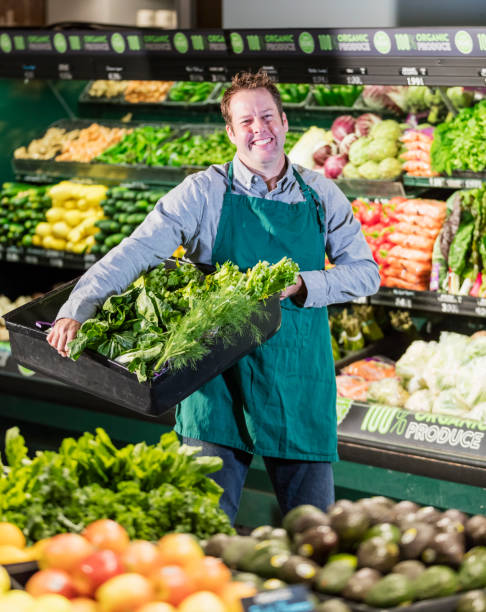 istock Man working in supermarket produce aisle 1171427373