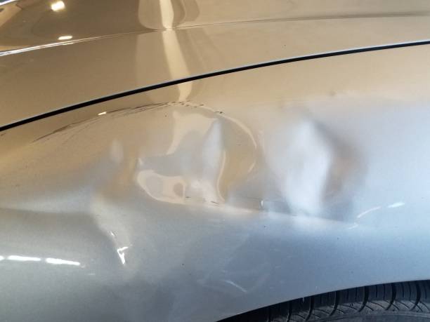 istock dent or damaged metal on white automobile 1171427993