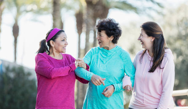 istock Three Hispanic women walking and talking in park 1171429213