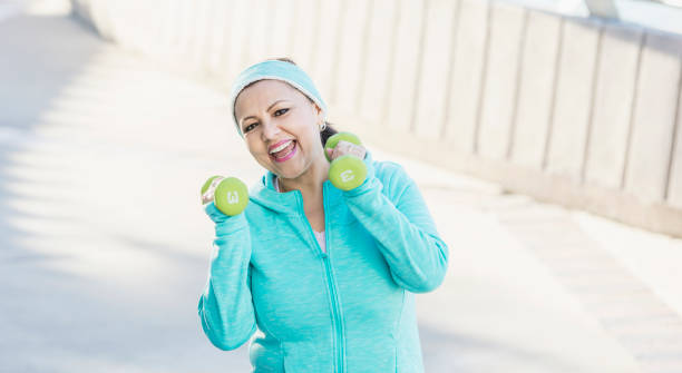 istock Mature Hispanic woman exercising with hand weights 1171429402
