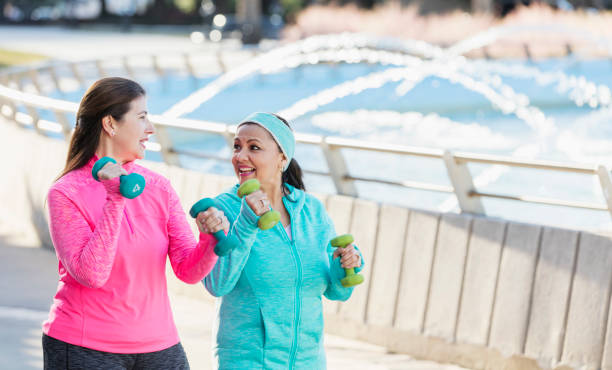 istock Two mature Hispanic women exercising with handweights 1171429511