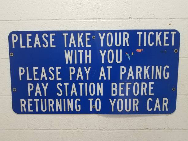 istock blue please take your parking ticket sign on wall 1171430353