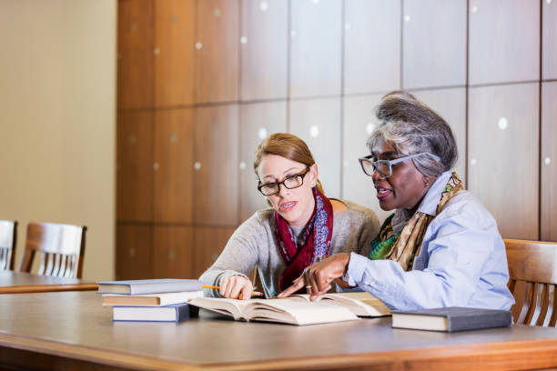 istock Two women doing research in the library together 1171430390