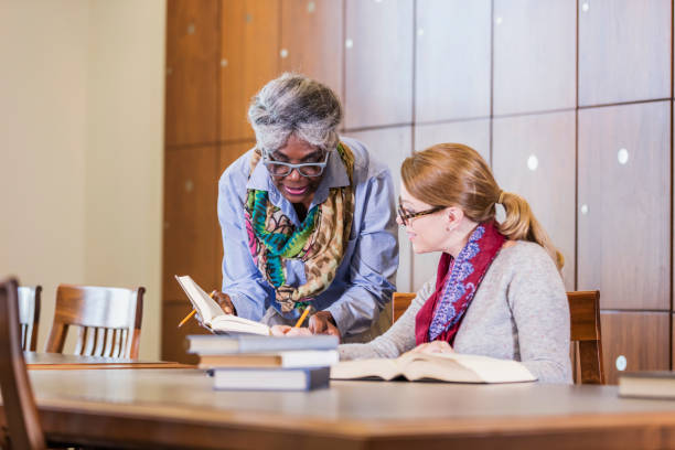 istock Two women doing research in the library together 1171430439