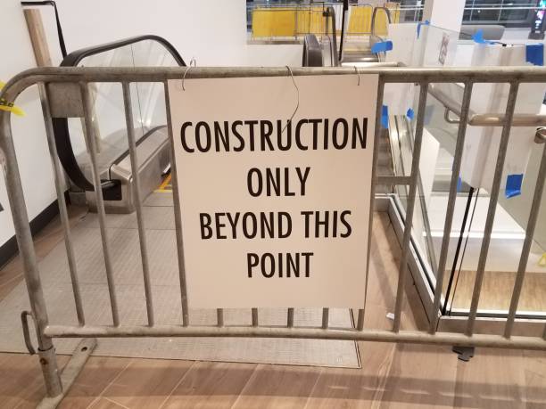 istock construction only beyond this point sign on metal fence near escalator 1171432240