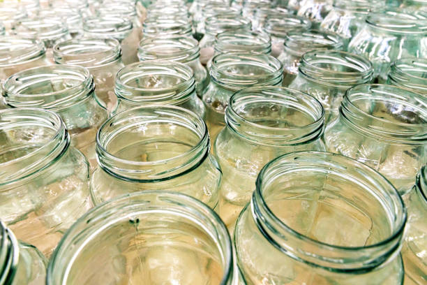 Lots of empty transparent jars in rows background stock photo