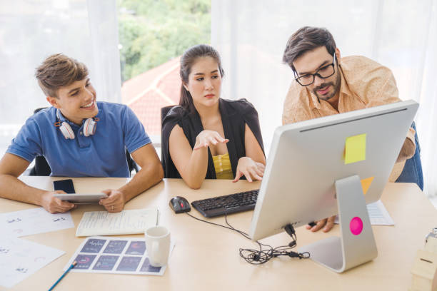istock Group Portrait young creative business person working success project with team Business people weare casual suit outfit working happy action in modern Coworking space and using computer to analysis stock market and investment in city background 1171437101