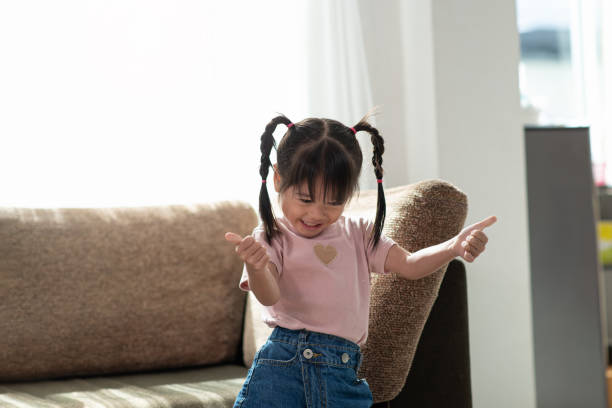 istock Happy Asian child having fun and dancing in a room 1171439487