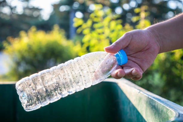 istock Throw the plastic bottle into the trash can 1171441347