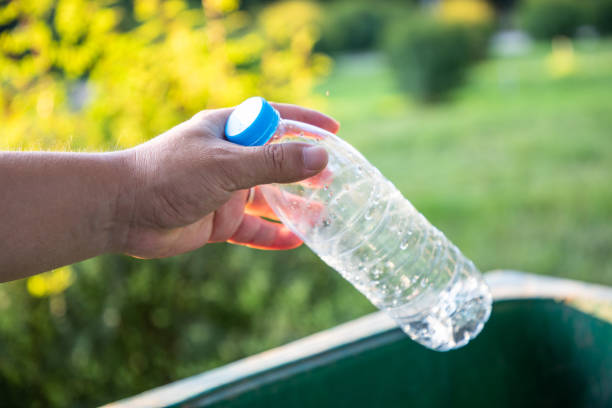 istock Throw the plastic bottle into the trash can 1171441428