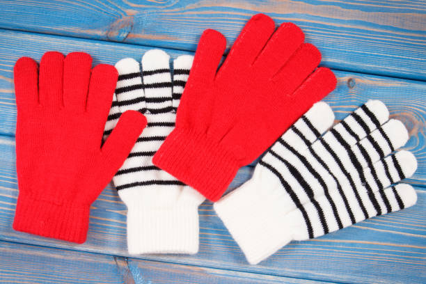 red and striped womanly gloves for autumn or winter - womanly imagens e fotografias de stock