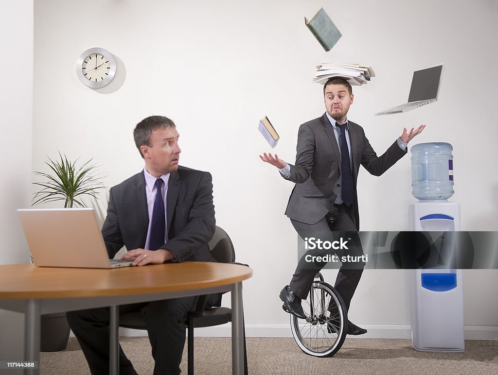 office multi-tasker younger office worker shows older colleague how to multi-task Humor Stock Photo