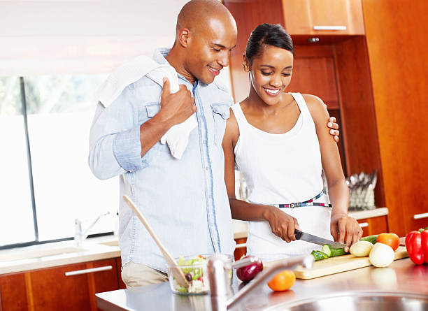 istock Happy couple cooking at home 117144443