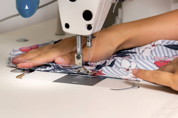 istock Woman tailor sews fabric on a sewing machine in the workshop. 1171445105