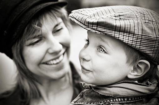 Close up portrait of beautiful mother and son hugging and laughing.