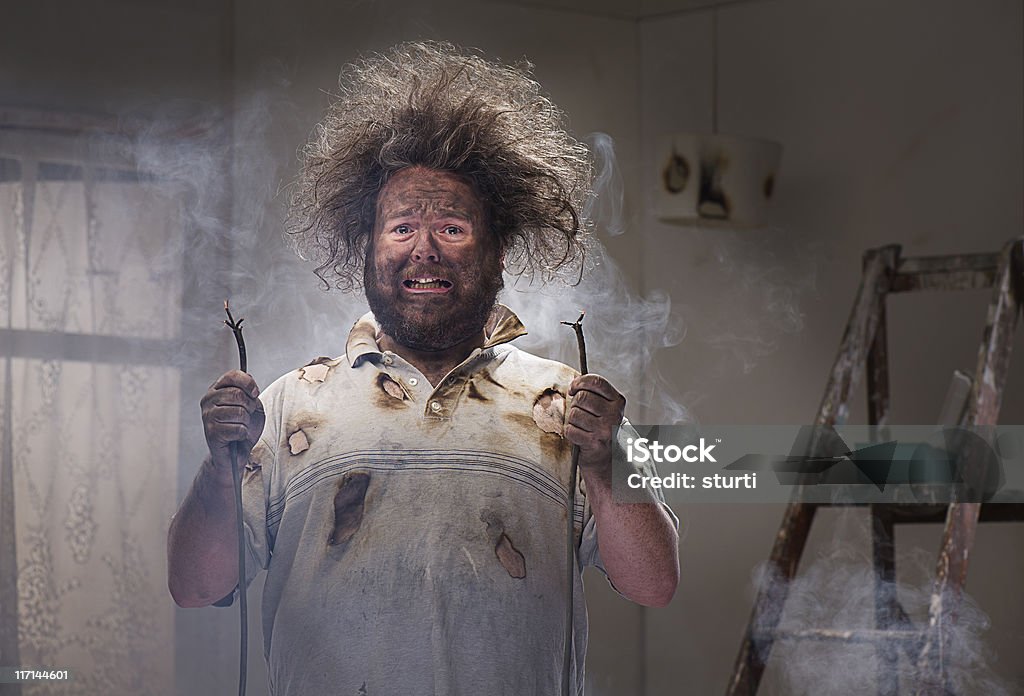 DIY disaster man gets a shock with his home improvements Humor Stock Photo