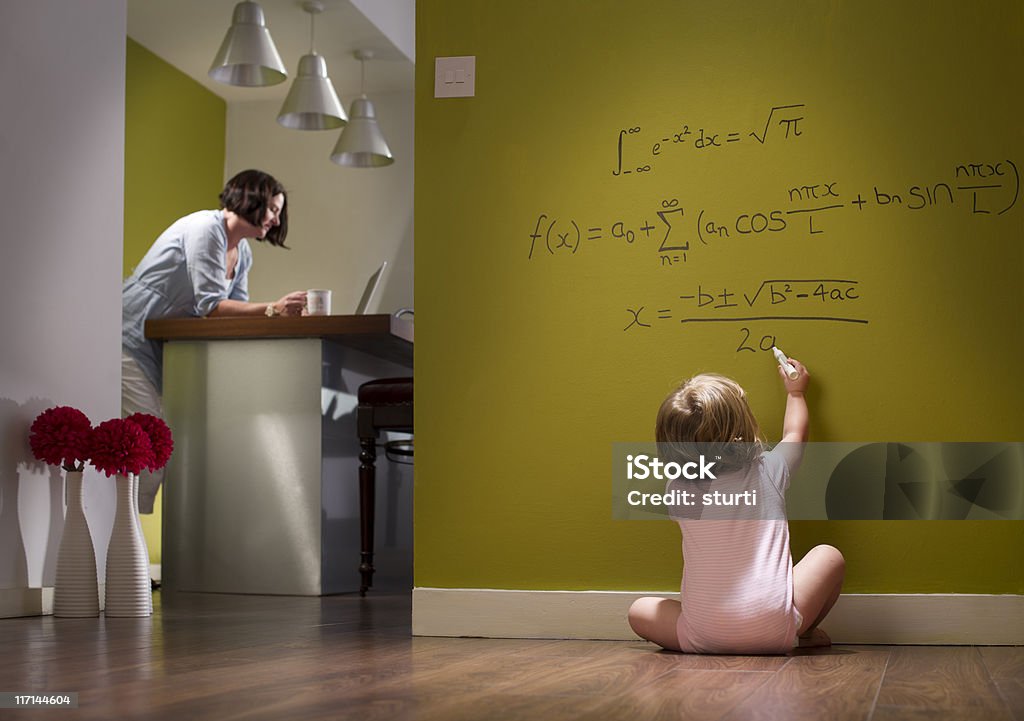child prodigy baby girl works out her equations whilst mum is oblivious Humor Stock Photo