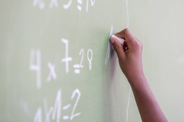 istock African child hand writing at chalkboard 1171446225