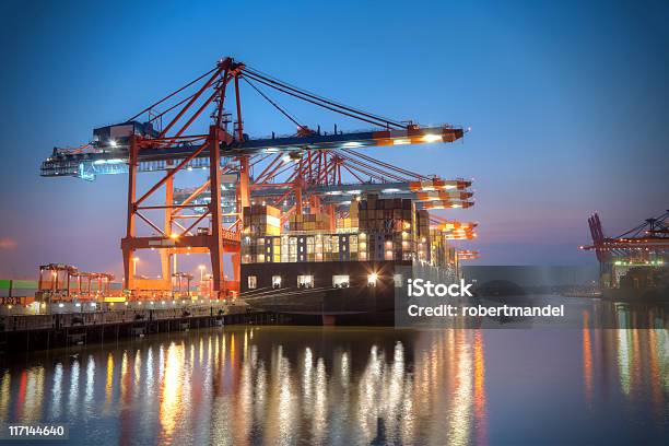 A Ship Docked At A Harbour At Night Time Stock Photo - Download Image Now - Harbor, Freight Transportation, Commercial Dock