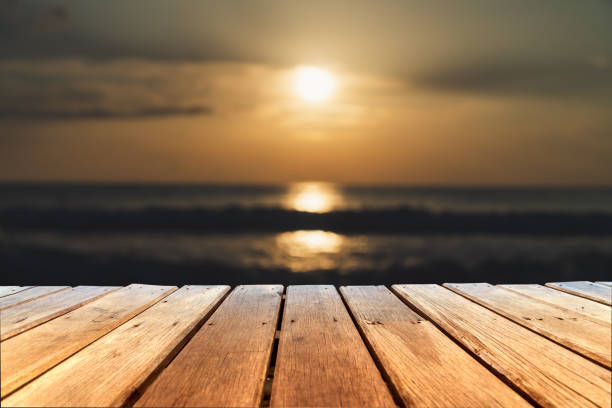 istock Selective focus of old wood table with blur beautiful beach background for display your product. 1171447240