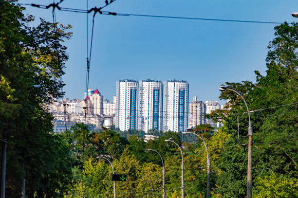 Urban houses on the horizon under a blue sky. City landscape.