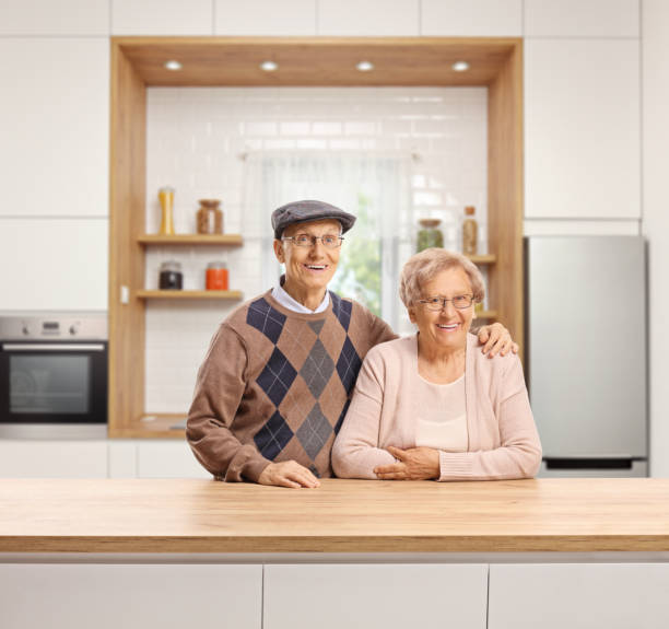istock Elderly man and woman standing in a kitchen 1171449443