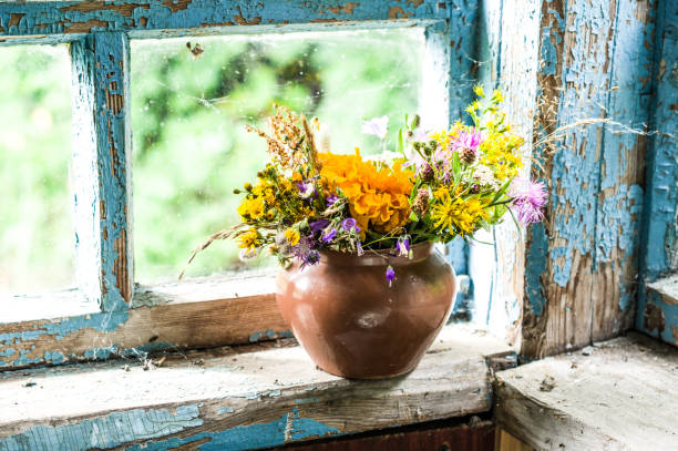 Rustic bouquet on the window. Old window. Cracked old paint. The village window.