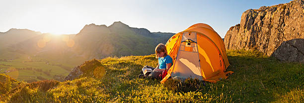 istock Sunset child camping on idyllic mountain top 117145173