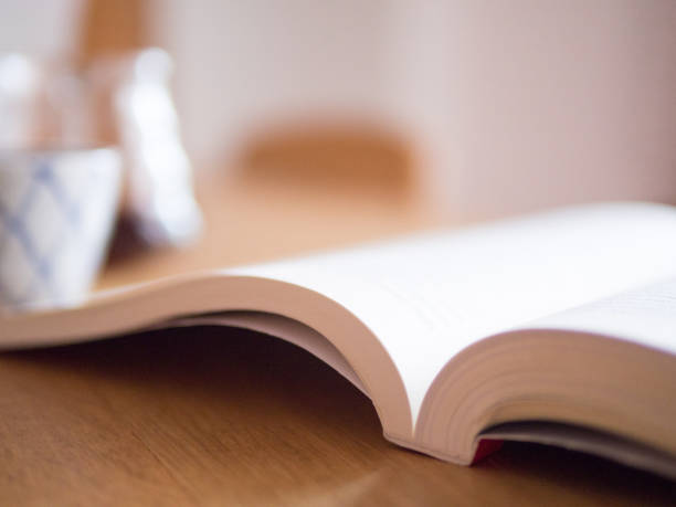 istock Book open on the wood table as a background. 1171452018