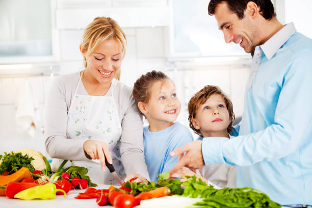 istock Happy family preparing a healthy dinner at home. 117145265