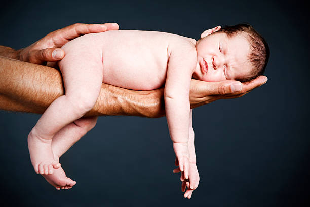 istock Baby boy sleeping on Dad's arm 117145330