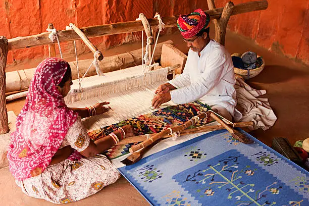 Photo of Indian couple weaving textiles (durry). Salawas village. Rajasthan.