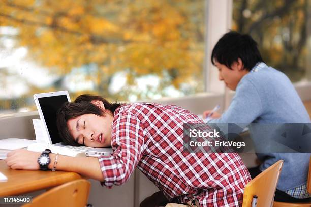 Two Asian Students Studying But One Has Fallen Asleep Stock Photo - Download Image Now