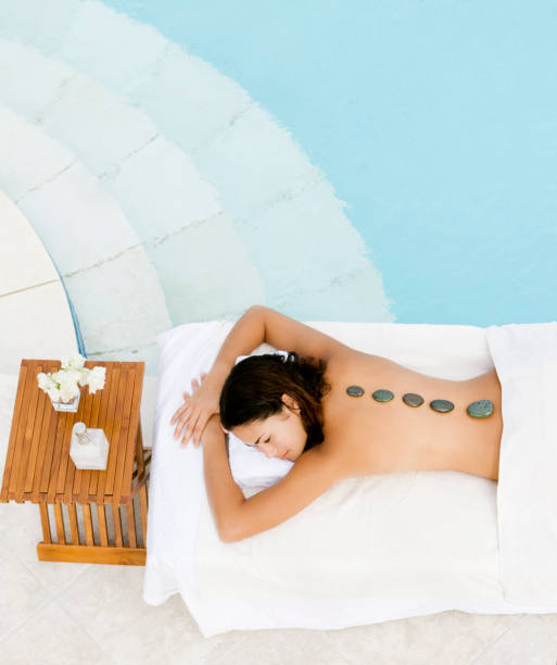 istock woman getting hot stone massage in a luxury spa resort 117145407