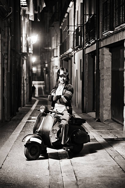 Happy retro biker. Happy retro biker, in the street at night. ( monochrome version ) mod stock pictures, royalty-free photos & images