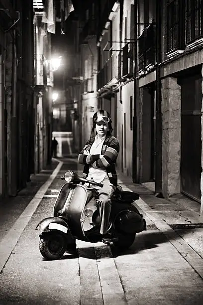 Happy retro biker, in the street at night. ( monochrome version )