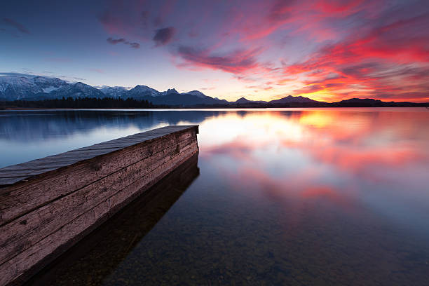 istock tranquil sunset at lake hopfensee in bavaria with pier- germany 117145477