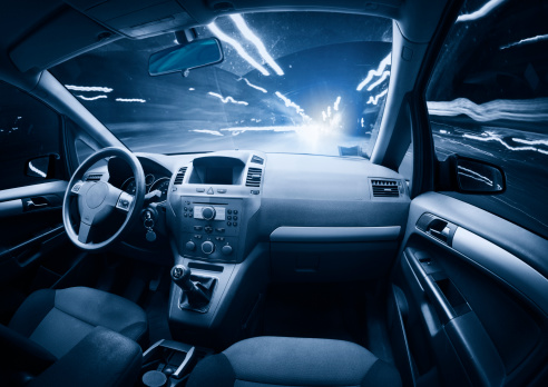 Driving through the City at Night. Interior view. Traffic car create the light.