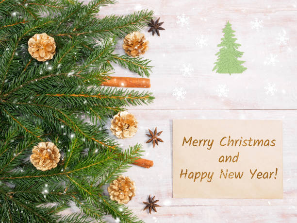 istock Christmas background with fir branches, snowflake, cinnamon, anise, gold cones, envelope on brown wooden background. Christmas and New Year concept 1171455636