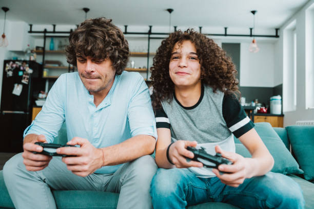 istock Father and son playing digital games at home 1171456803