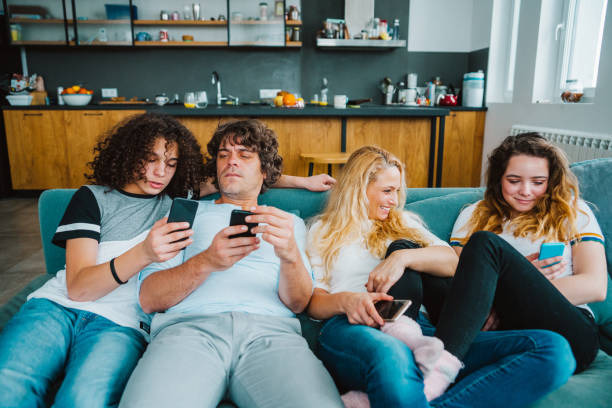 istock Family using smart phones  while relaxing on the sofa 1171456810