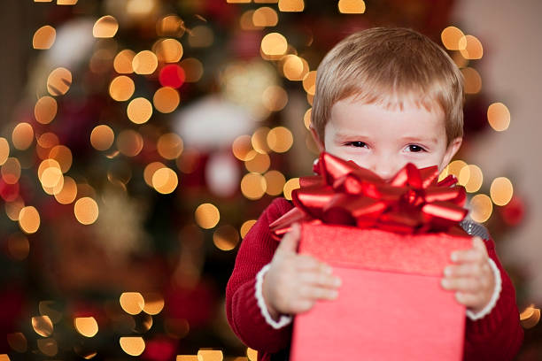Young Boy Smiles with his Christmas Present stock photo