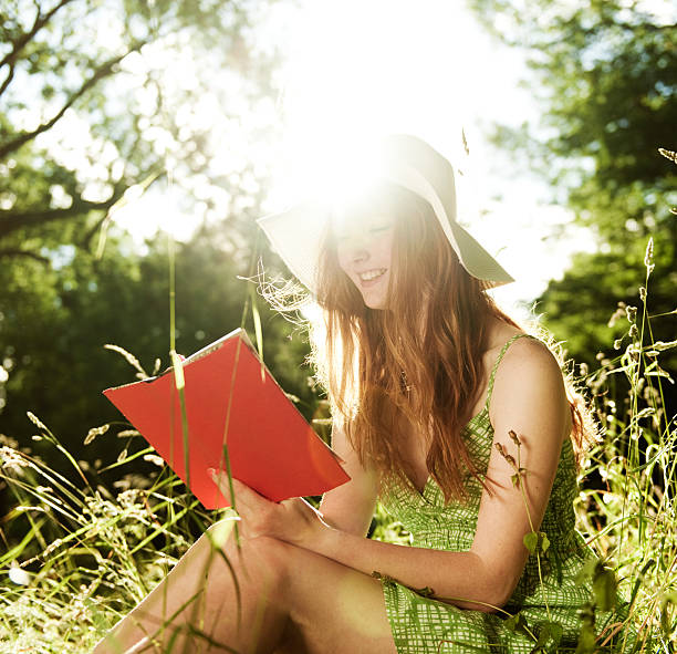 Young Woman reading in the park