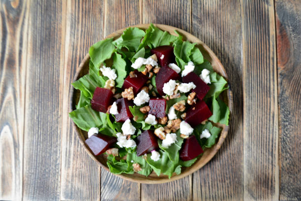 istock Warm autumn beetroot salad with soft cheese, walnuts and spinach in a plate on a wooden background 1171457715