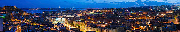Lisbon vibrant illuminated cityscape super panorama Portugal The landmarks of Lisbon illuminated by the warm glow of street lights under deep blue dusk skies. ProPhoto RGB profile for maximum color fidelity and gamut. santa justa lift portugal stock pictures, royalty-free photos & images