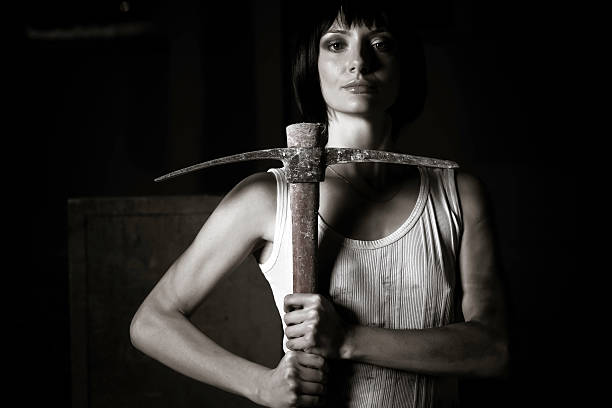 istock Young woman holding mattock 117145833