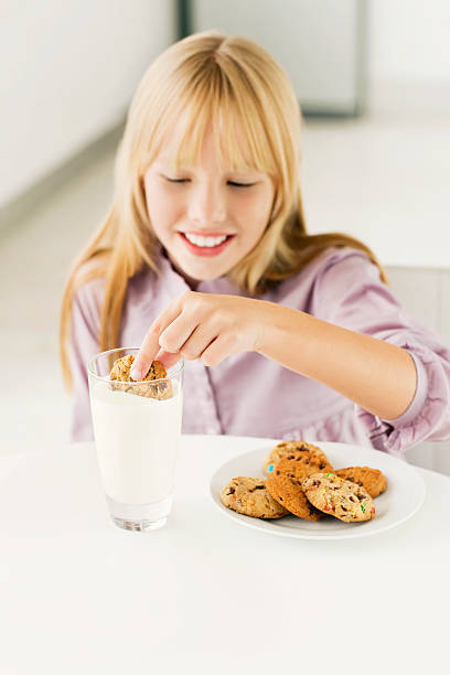istock Young Girl Dunking a Cookie in Milk 117145954