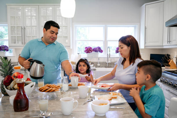 istock Hispanic family enjoying breakfast together in the kitchen 1171460957