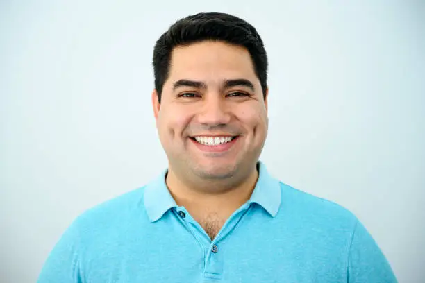 Photo of Headshot portrait of smiling mature Hispanic man