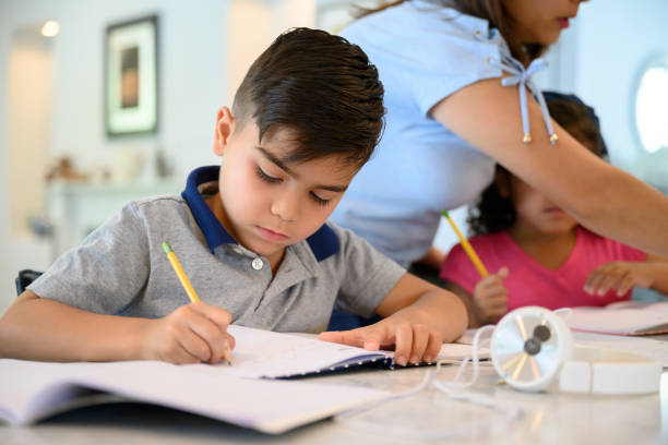 Young Latin American boy concentrating on his homework